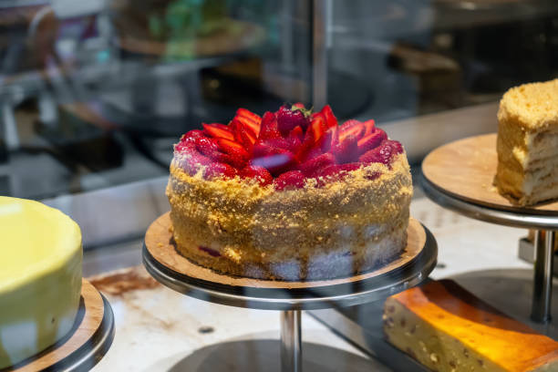 istock A delicious cake decorated with strawberries stands on the display case. 2182448132
