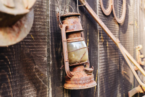 istock Antique kerosene lamp with rustic metal and glass structure. Old-fashioned lantern flea market. 2182449575