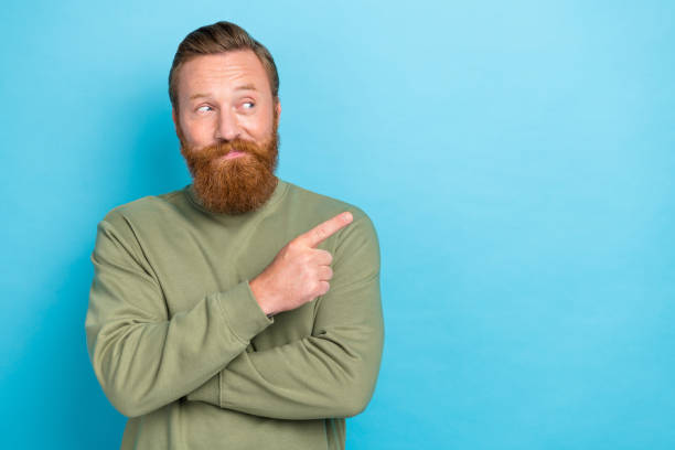 istock Portrait of cheerful funny guy with ginger hairdo wear khaki pullover indicating look empty space isolated on turquoise color background 2182452877