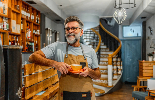 istock Mature barista having a coffee break 2182453328