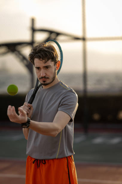 istock Handsome man playing tennis outdoors in his spare time 2182454018