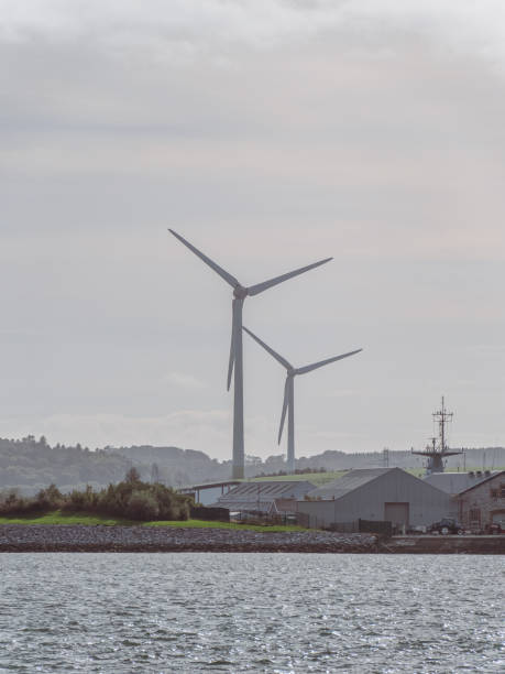 istock Wind power generators in the Ireland, landscape. Two wind turbines located in Ringaskiddy, County Cork. Cloudy overcast sky. wind turbine under cloudy sky 2182455409