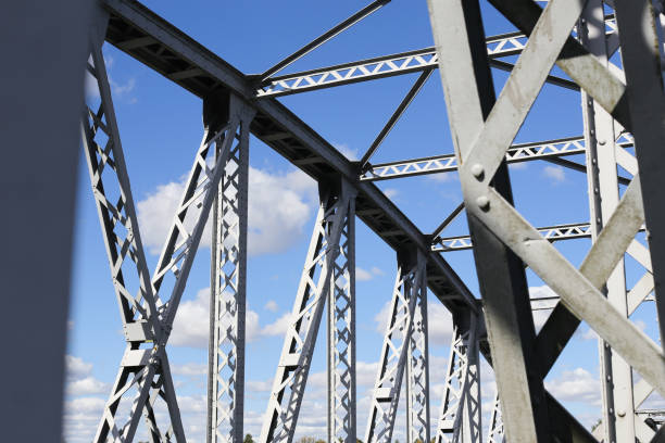 istock Metal bridge background. Road bridge construction. Empty asphalt road. Blue sky weather long bridge over Narew river. 2182460095