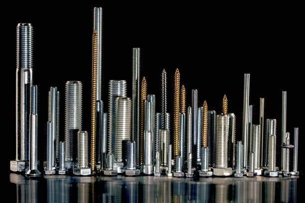 Different sizes of screws on black background,