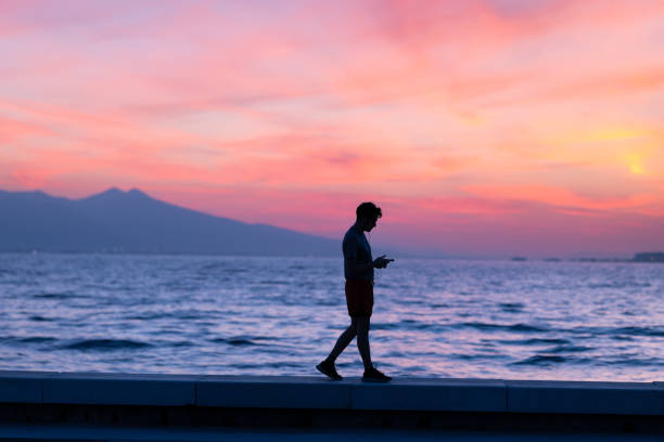 Rear view of adult man on beach during sunset. Almeria, Andalusia, Spain