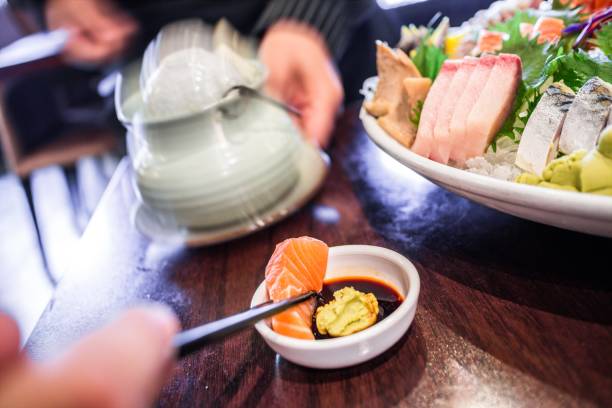 istock A person eating sashimi with chopsticks 2182461029