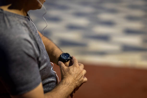 istock Unknown mature Man exercising outdoors checking his pulse on his smart watch 2182461083