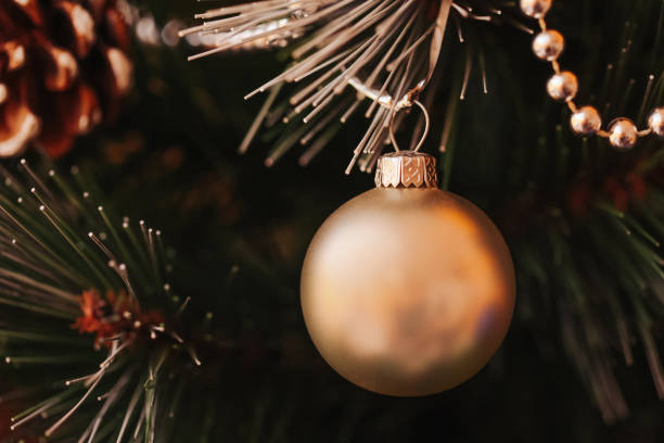 istock Christmas ornament on a festive background. Christmas tree bauble on a tree. Decorated tree with pinecones and garlands. 2182461729