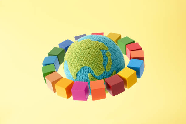 istock SDGs symbols and a wooden cube with knitted earth 2182466252