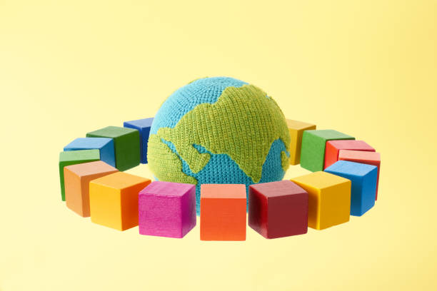 istock SDGs symbols and a wooden cube with knitted earth 2182466264