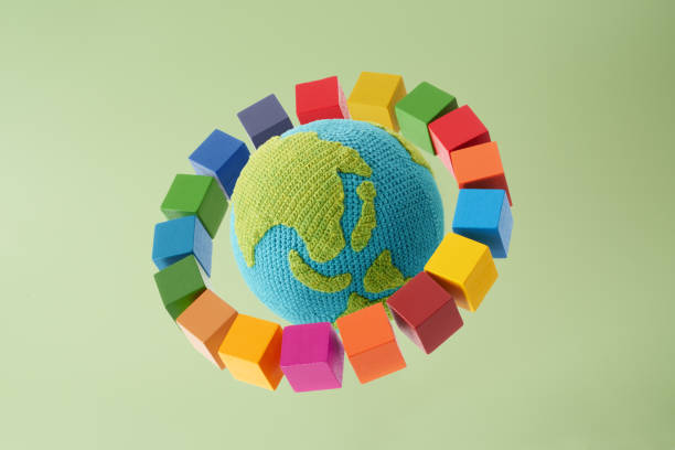 istock SDGs symbols and a wooden cube with knitted earth 2182466298