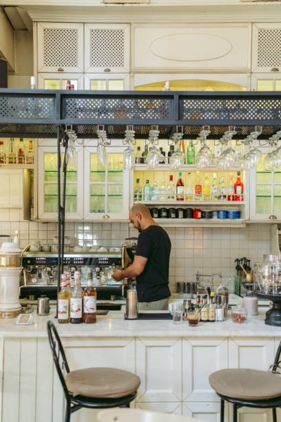 istock Bartender preparing drink in a cozy and well-stocked bar 2182469268