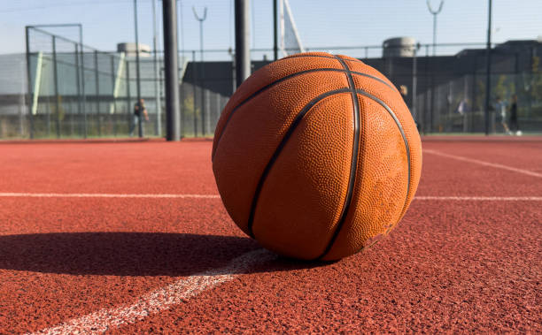 istock Basketball ball on a public playing court 2182469280