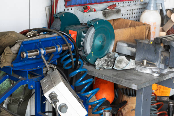 Mess on a working table with metallic tools and metal vice, tires pressure, garage workshop