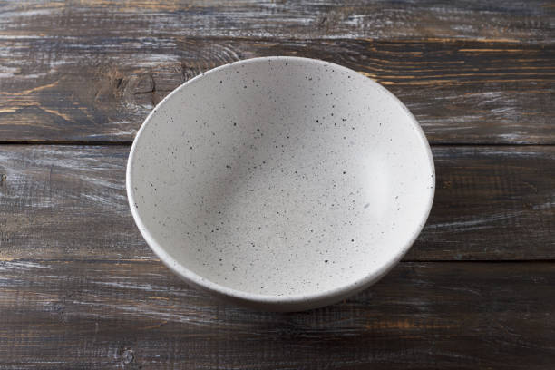 istock Simple empty light gray ceramic bowl on wooden table, rustic style, top view, mockup, for graphic design, creativity 2182472501