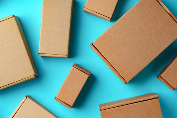 A collection of cardboard boxes arranged on a bright blue surface