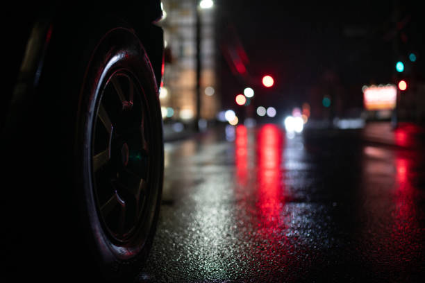 istock A crosswalk and car tires on a rainy night 2182484828