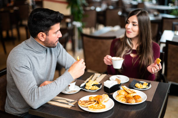 istock Couple enjoying breakfast together at restaurant table 2182485722