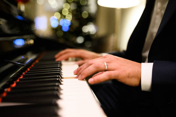 istock Musician playing piano during christmas party 2182486083