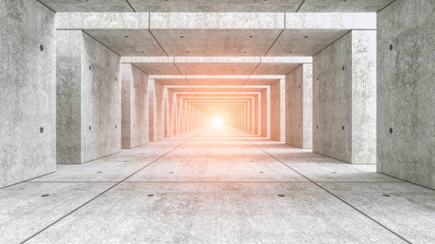 Futuristic concrete tunnel with bright light at the end