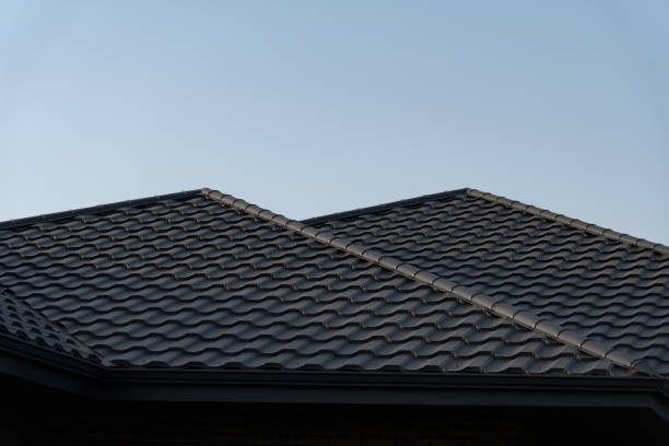 istock The structure showcases a contemporary metal tile roof with a wave pattern, set against a bright blue sky. This roofing choice enhances the home's aesthetic appeal and durability 2182489633