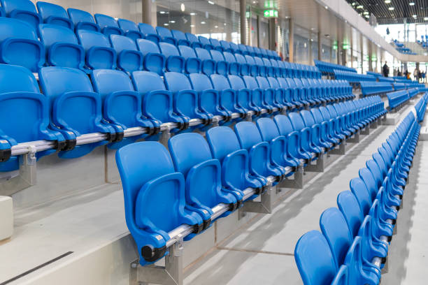 istock A long row of modern blue chairs with folding seats in a hall 2182493500