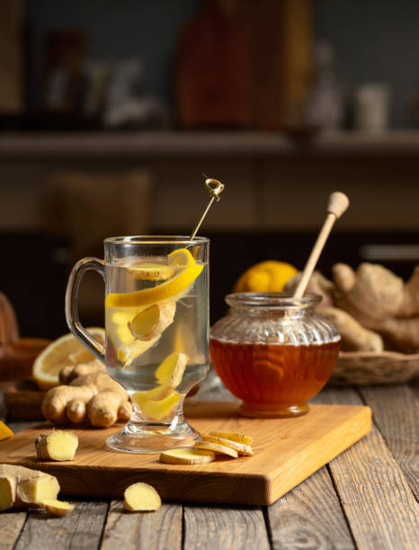 istock Ginger tea with lemon and honey on an old wooden table. 2182495448