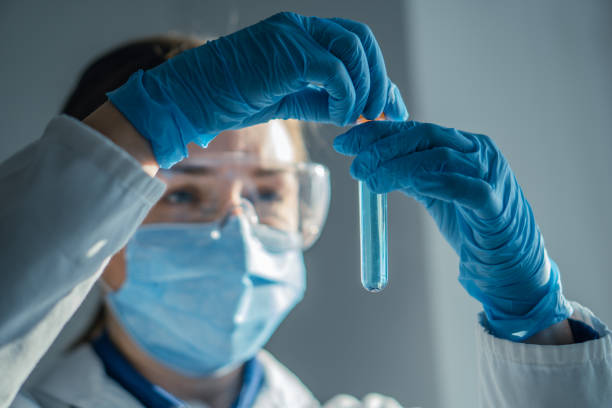 A dedicated Laboratory Research Scientist is currently conducting an intricate chemical experiment utilizing a test tube, focusing on the complexities and nuances of various chemical reactions