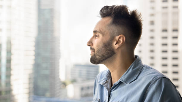 istock Dreamy young Latin man looking at city scape, enjoying view 2182497865