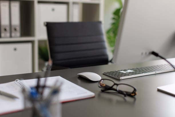 istock Shot of PC computer and office supplies on a desk 2182501716