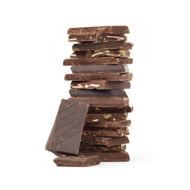 istock Dark noir chocolate different pieces with salted caramel, cacao splits in stack isolated on white 2182502938