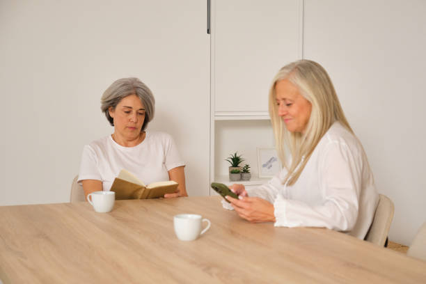 istock Senior women reading and using smartphone at home 2182503914