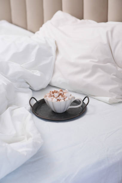 istock Enjoy a cozy morning with coffee, soft bedding, and a warm atmosphere for relaxation 2182507038