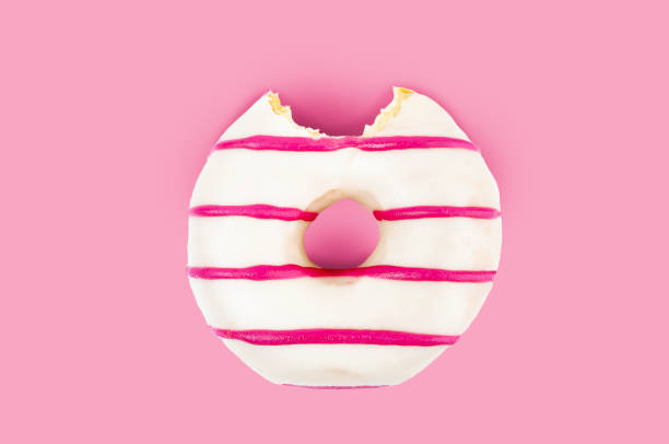 missing bite of pink striped and white chocolate donut