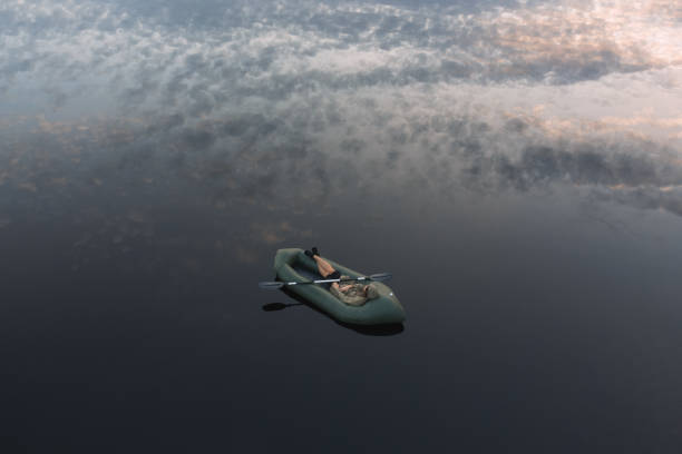 istock A man dozes in a packraft on the mirror surface of the water 2182508283