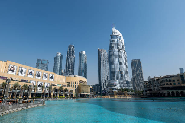 Dubai, UAE - December 6. 2019 - the shiny Burj Khalifa in Dubai is currently the tallest building in the world and one of the most photographed. In front of the Burj is a beautiful artificial lake with a fountain and the Dubai Mall. Many tourists visit this attraction every day.