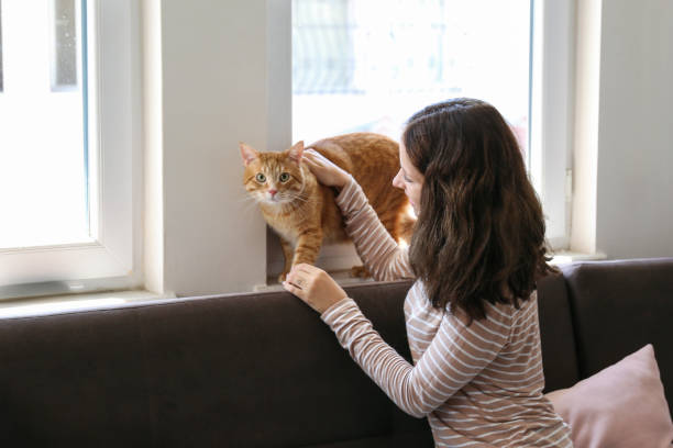 istock Young woman and her red cat 2182509021