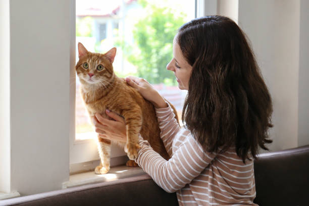 istock Young woman and her red cat 2182509025