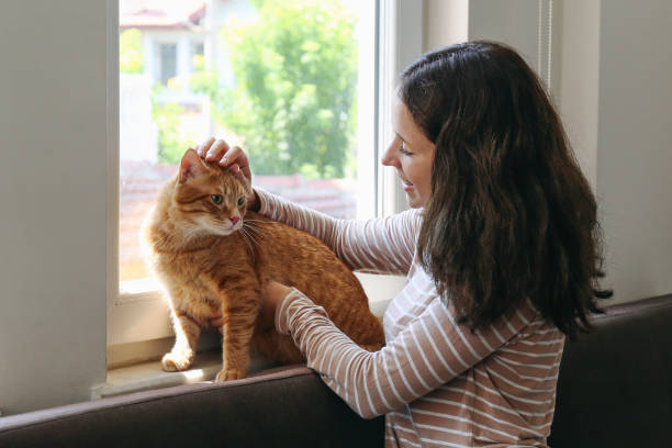 istock Young woman and her red cat 2182509036