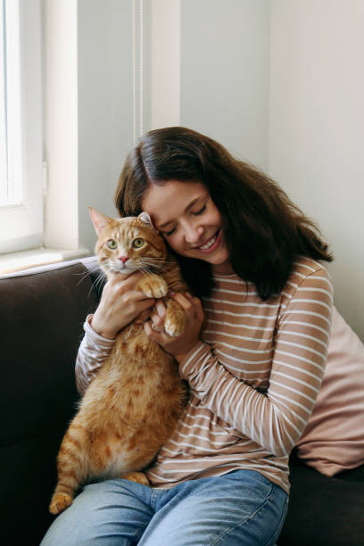 istock Young woman and her red cat 2182509047