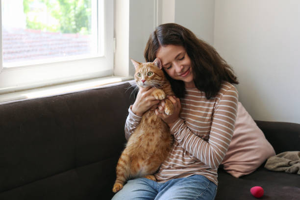 istock Young woman and her red cat 2182509073