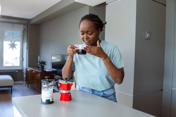 istock Woman enjoying morning coffee in a bright kitchen 2182515716