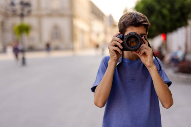 istock Teenager Taking Picture With Camera Outside 2182515767