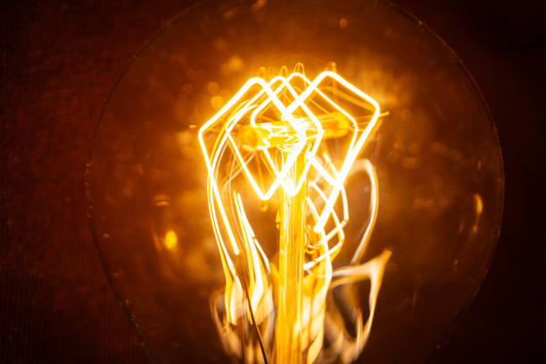 Creative light bulb with filament glows in the dark. Electricity and energy, creative idea. Think different, concept.
