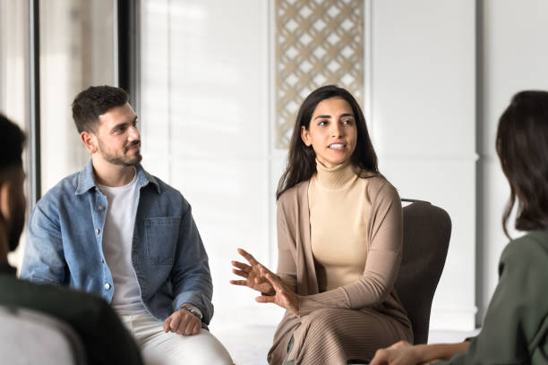 istock Group therapy female Latin doctor talking to diverse patients 2182516945