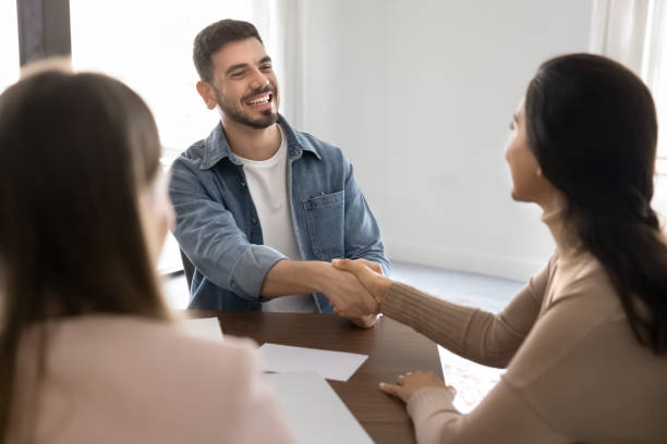 istock Happy young Middle Eastern business professional man giving handshake 2182517219