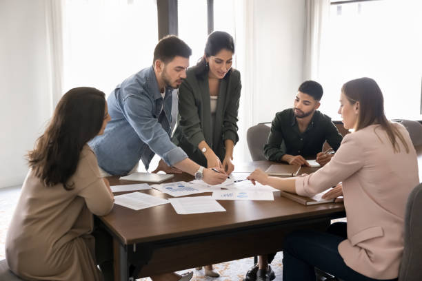 istock Focused busy diverse project colleagues analyzing sales statistic charts 2182517870