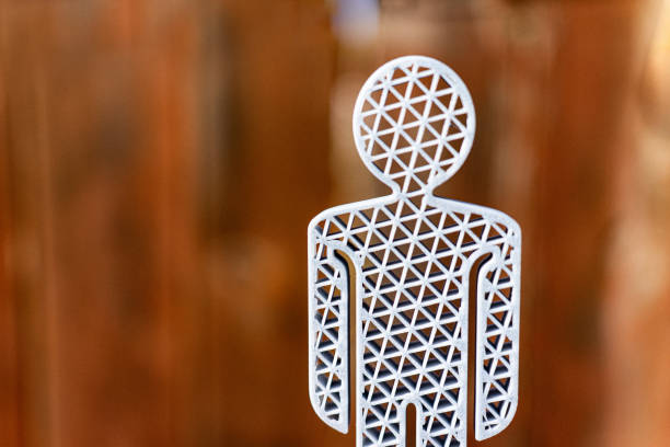 : A close-up image of a cutout design depicting a human figure in the center, surrounded by intricate mandala patterns that create an eye-catching visual effect on a dark background