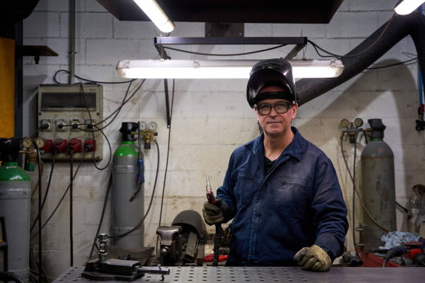 istock Metal worker holding welding torch in workshop 2182521281