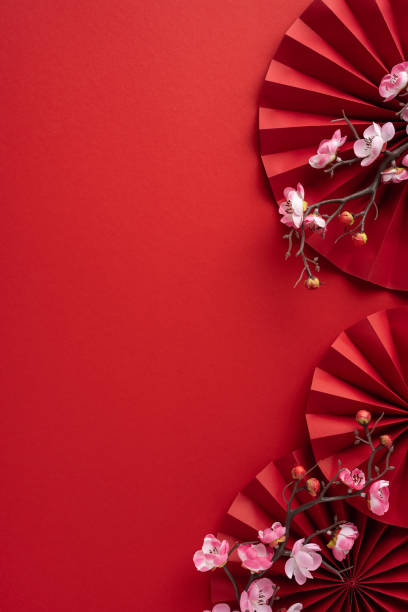 istock Vibrant vertical red paper fan with delicate cherry blossoms creates a festive and elegant atmosphere, perfect for celebrating Chinese New Year or any cultural event 2182522023